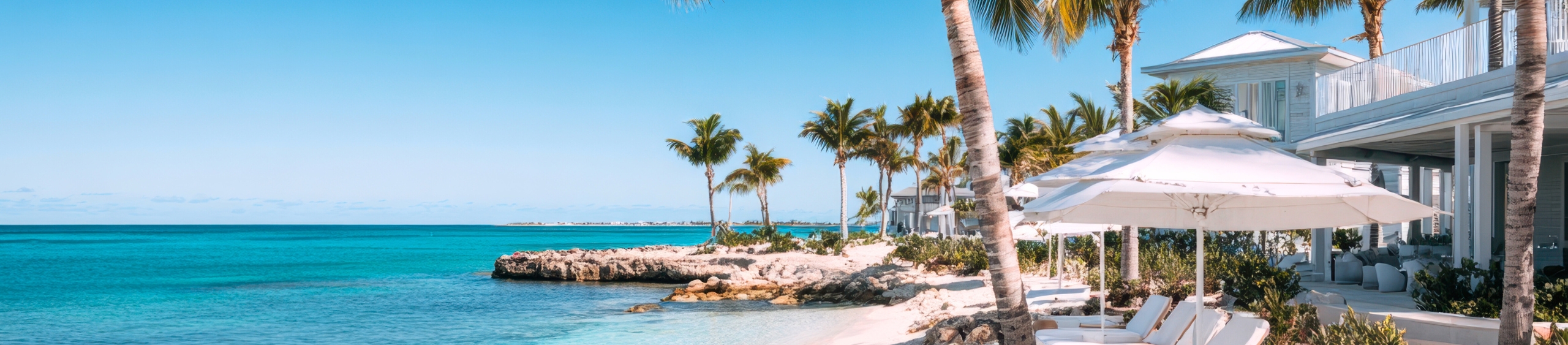 Luxury Beachfront resort in the Caribbean with turquoise water and white umbrellas