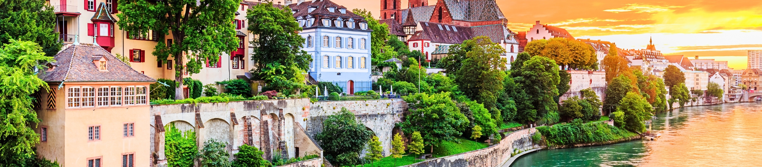 Colorful hillside village in Switzerland with charming historic buildings and lush greenery.